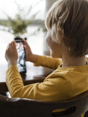 smiley-boy-using-smartphone-home